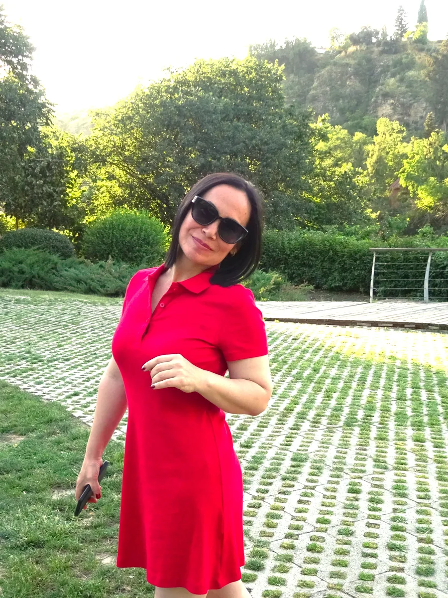 Selbi Clean private cleaning specialist in Tbilisi wearing a red dress outdoors